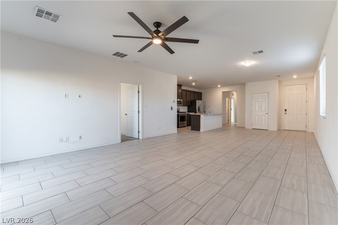 5740 Saltrock Grove Street, North Las Vegas, NV 89081 Clean tile flooring and high ceilings define this versatile open living space.