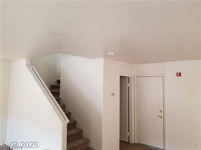 3123 Inlet Bay Avenue, North Las Vegas, NV 89031 A carpeted staircase ascends from the main living level near the entry door.