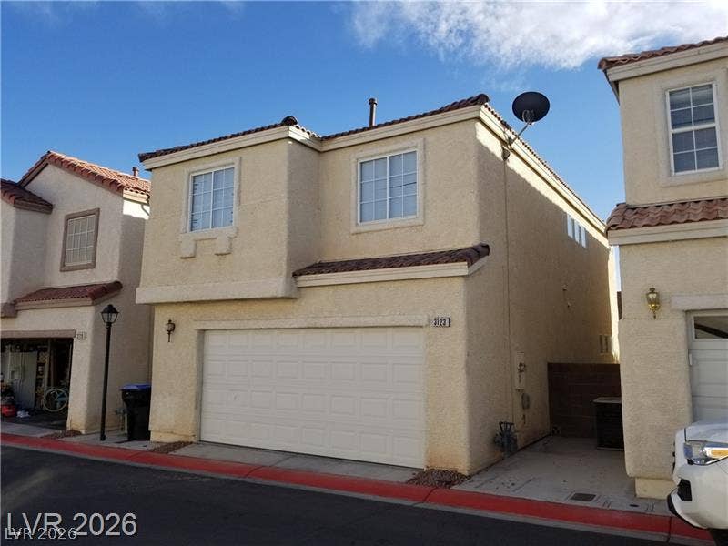 3123 Inlet Bay Avenue, North Las Vegas, NV 89031 Stucco exterior siding and Spanish tile roof accents define this two-story home with attached garage.