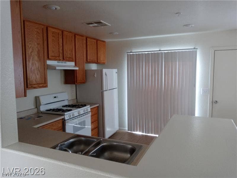 3123 Inlet Bay Avenue, North Las Vegas, NV 89031 Functional kitchen design links seamlessly with adjacent living spaces through a convenient pass-through breakfast bar.