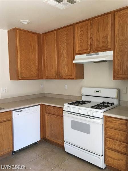 3123 Inlet Bay Avenue, North Las Vegas, NV 89031 Ample wooden cabinetry and tile flooring define this functional cooking space.