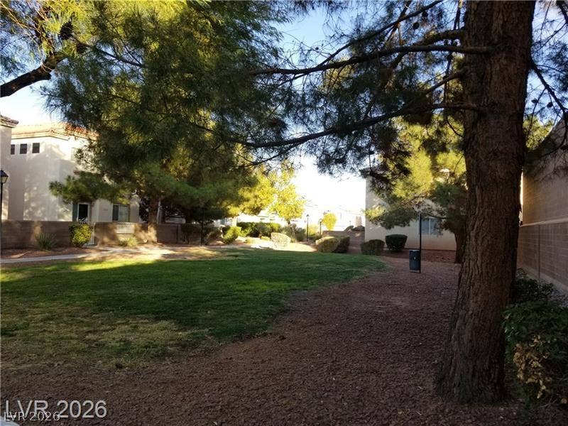 3123 Inlet Bay Avenue, North Las Vegas, NV 89031 Mature trees shade a central green belt with winding concrete walkways throughout the community.