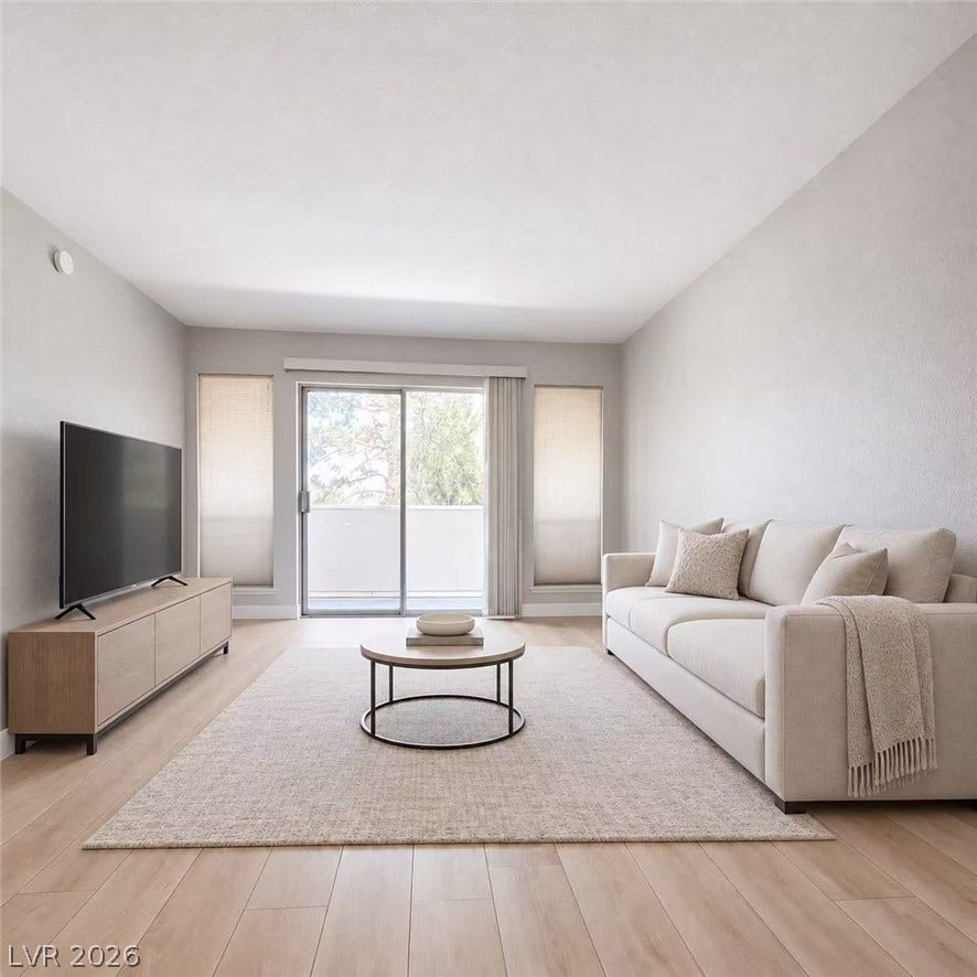 2838 Loveland Drive, #1608, Las Vegas, NV 89109 Sliding glass doors open to a private balcony from this modern living space.