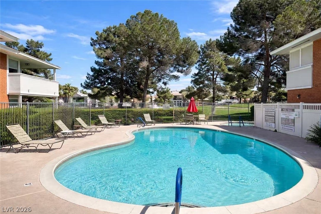 2838 Loveland Drive, #1608, Las Vegas, NV 89109 A sparkling community pool sits surrounded by mature pines and a paved lounging patio.