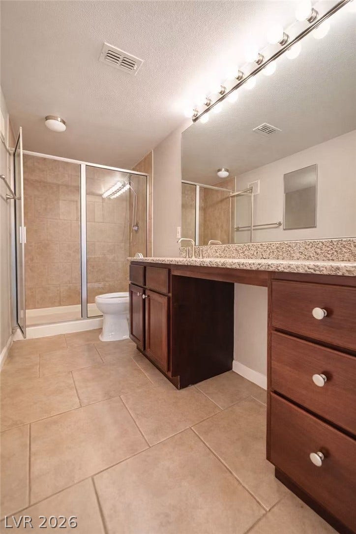 2838 Loveland Drive, #1608, Las Vegas, NV 89109 A spacious vanity with stone countertops highlights this functional bathroom featuring a walk-in shower.