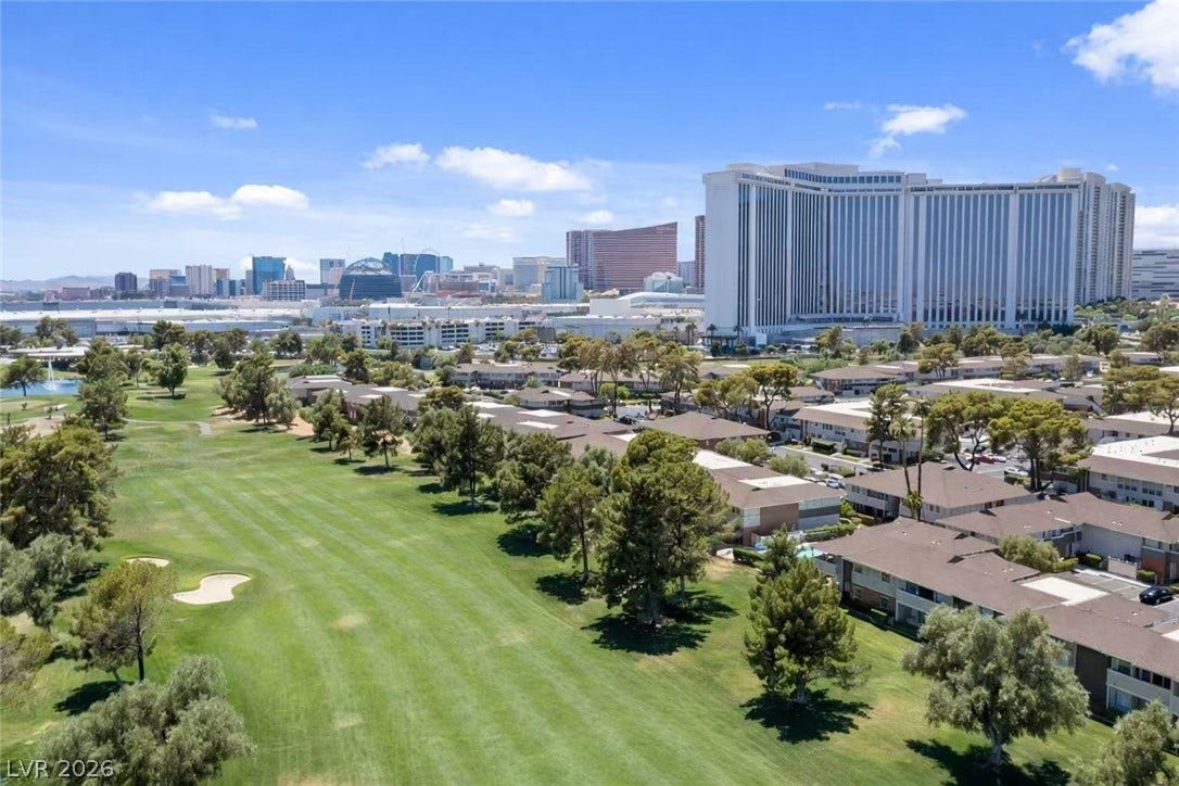 2838 Loveland Drive, #1608, Las Vegas, NV 89109 Swaying trees border a green golf course fairway set against a distant city skyline.