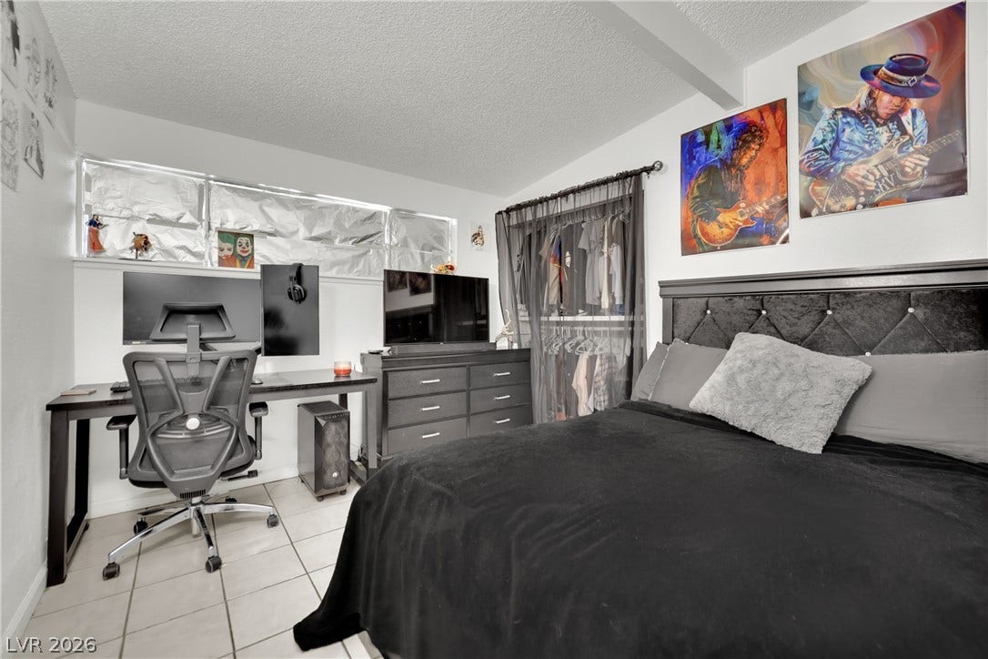 Tiled flooring and a built-in closet system define this versatile bedroom space.