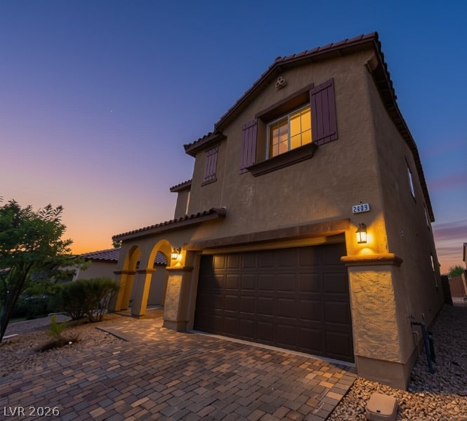 Stucco exterior walls paired with a tile roof define this two-story residential structure.
