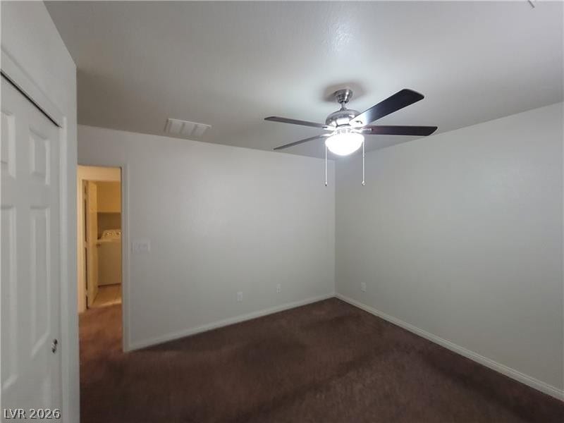 Smooth walls and classic baseboards frame a quiet bedroom featuring soft carpeting.