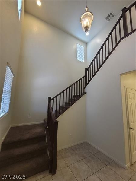 Soaring ceilings and a dramatic staircase define this welcoming entry space.