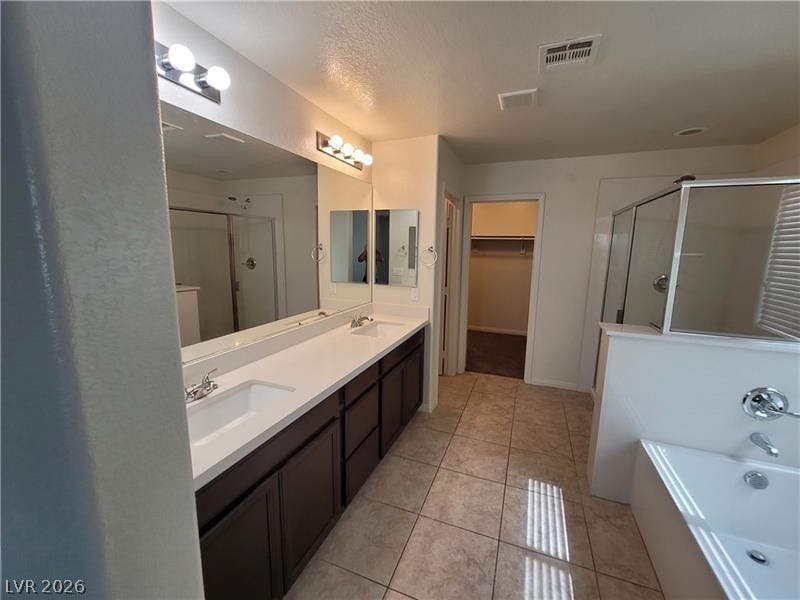 Clean tile flooring and a double vanity define this spacious bathroom layout.