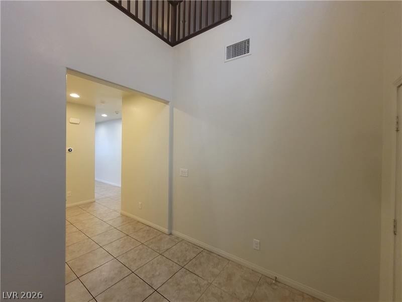 Tiled flooring and high ceilings define this welcoming entryway.