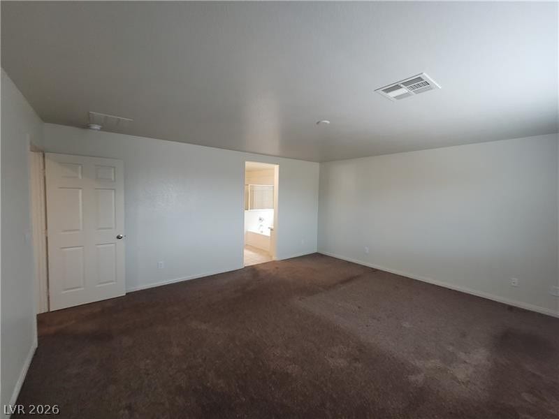 Plush carpeting underfoot extends throughout this primary suite complete with an attached bath.