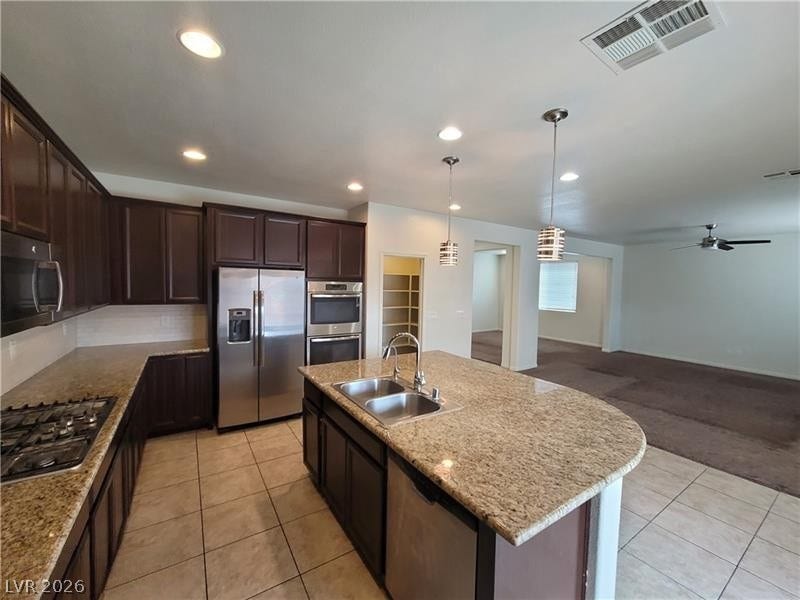 An open floorplan connects the modern kitchen with granite countertops to the living spaces.