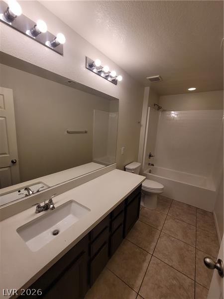 Clean tile flooring and a dual vanity with built-in storage anchors this full bathroom.