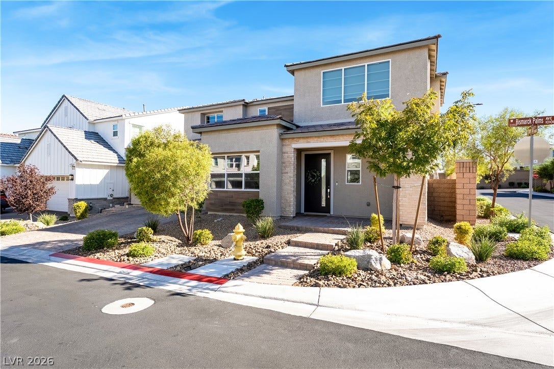 10143 Bismarck Palms Avenue, Las Vegas, NV 89166 A modern two-story exterior highlights clean architectural lines and xeriscaped front yard landscaping.