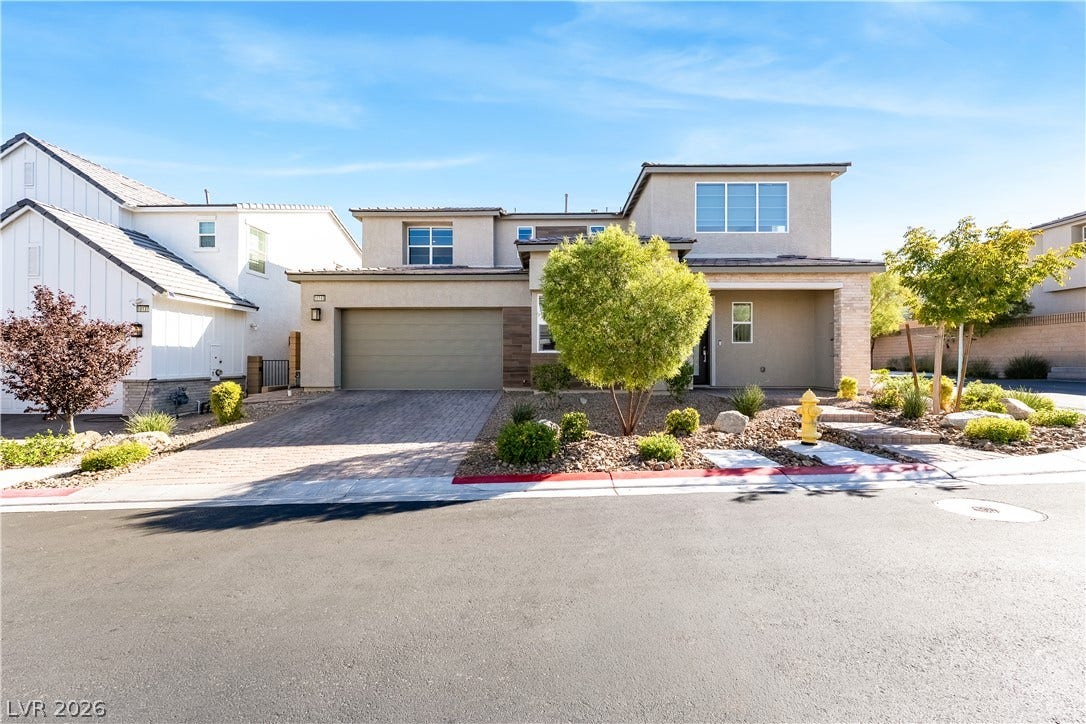 10143 Bismarck Palms Avenue, Las Vegas, NV 89166 A modern two-story exterior showcases clean architectural lines and professional desert landscaping.