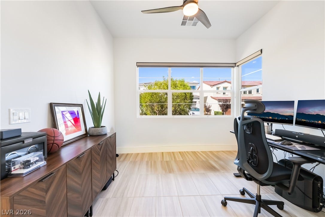 10143 Bismarck Palms Avenue, Las Vegas, NV 89166 Clean lines and wood flooring define this versatile home workspace with abundant natural light.