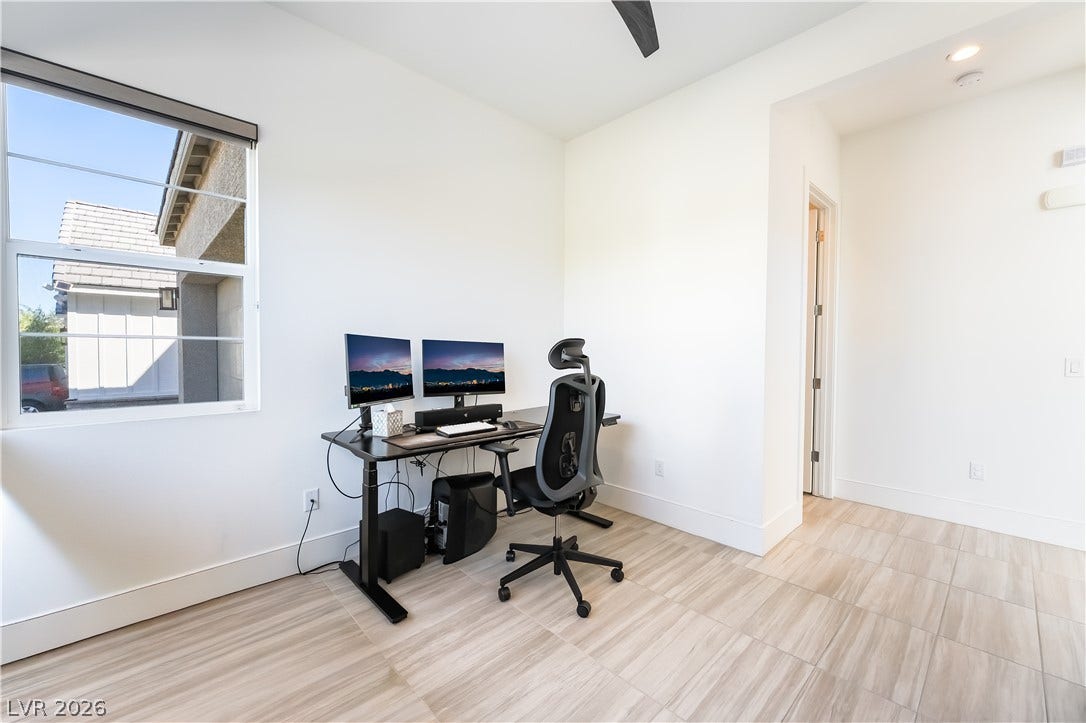 10143 Bismarck Palms Avenue, Las Vegas, NV 89166 Gleaming tile floors run throughout this versatile home office area with tall windows.