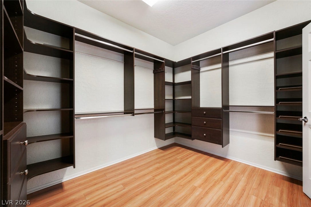 7421 Shelduck Street, North Las Vegas, NV 89084 Custom dark wood shelving and smooth wood flooring define this organized storage space.