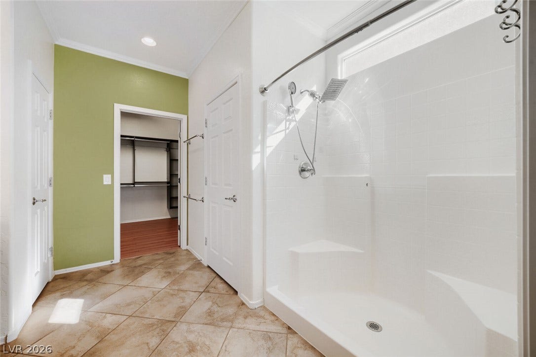 7421 Shelduck Street, North Las Vegas, NV 89084 An integrated walk-in shower sits adjacent to the tiled floor and walk-in closet entryway.