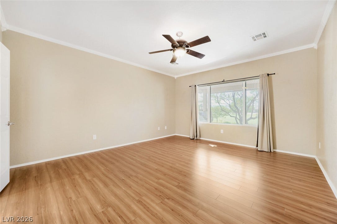 7421 Shelduck Street, North Las Vegas, NV 89084 Polished wood floors and a large picture window define this versatile living space.