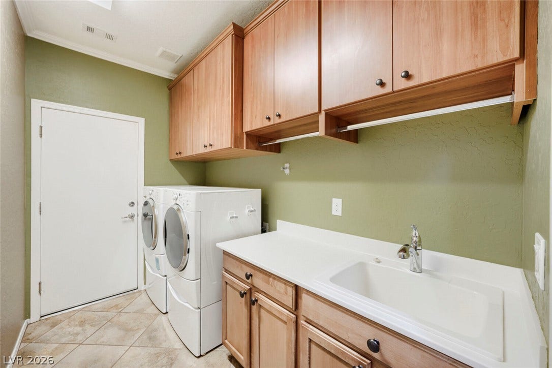7421 Shelduck Street, North Las Vegas, NV 89084 Ample wooden cabinetry and a built-in sink provide exceptional utility in this functional space.