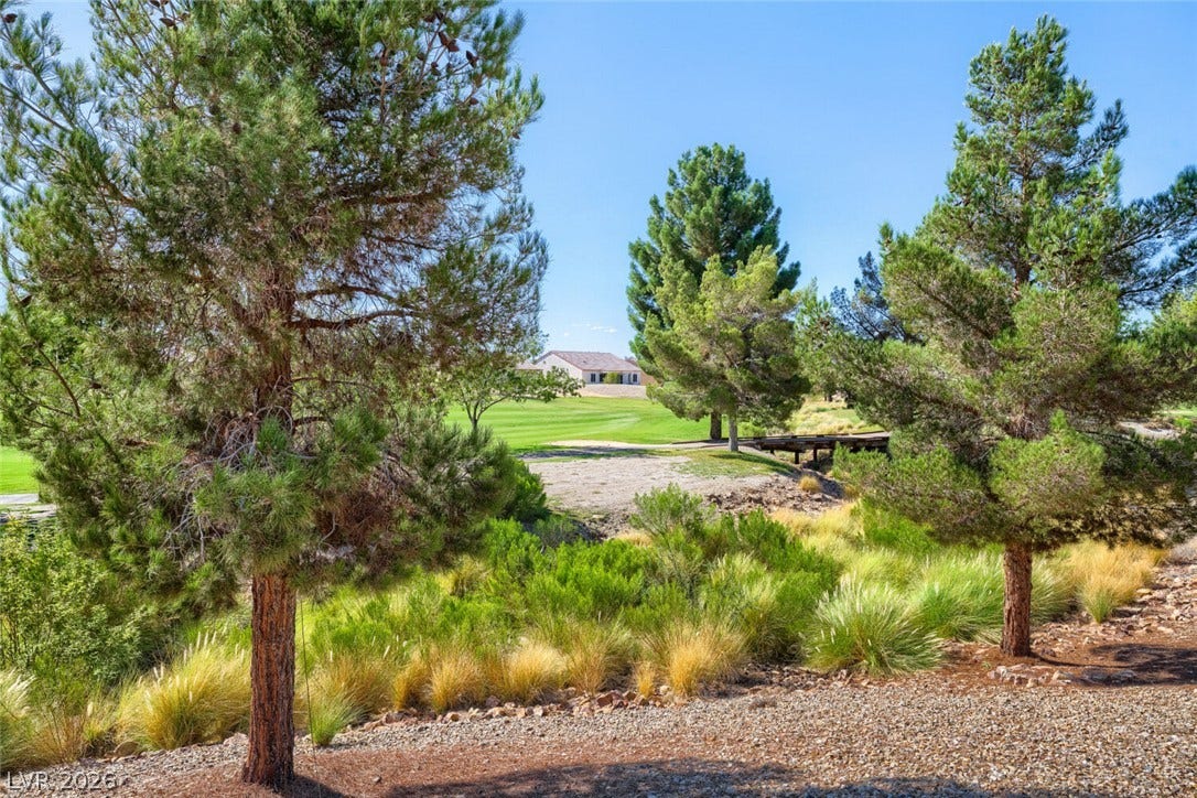 7421 Shelduck Street, North Las Vegas, NV 89084 Mature trees and native grasses border the fairway of this desert golf course community.