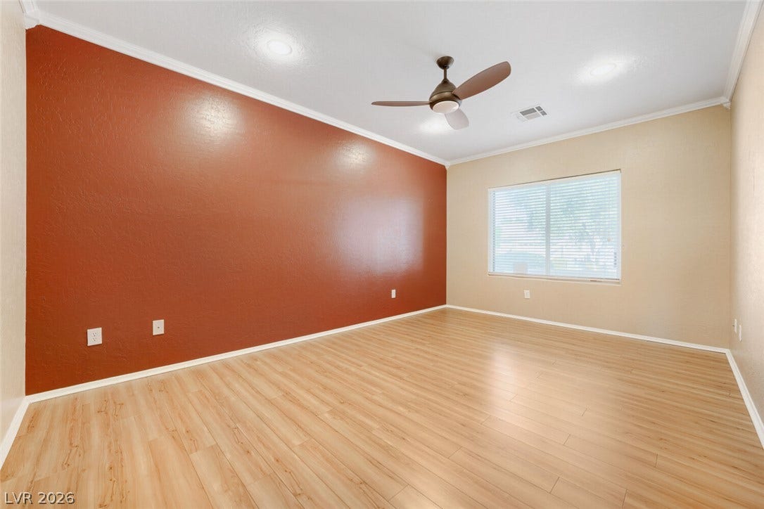 7421 Shelduck Street, North Las Vegas, NV 89084 Smooth wood floors and crown molding define this versatile living space.