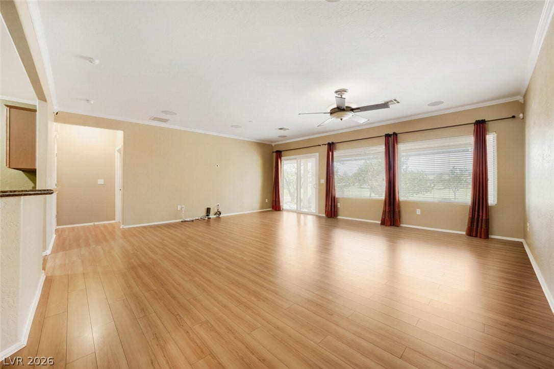 7421 Shelduck Street, North Las Vegas, NV 89084 Polished wood floors and expansive windows define this generous living space.
