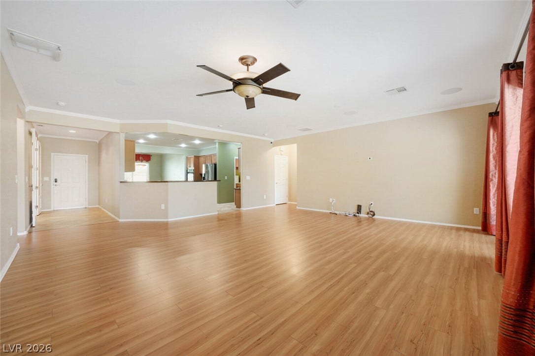 7421 Shelduck Street, North Las Vegas, NV 89084 Smooth wood floors and crown molding define this open interior space.