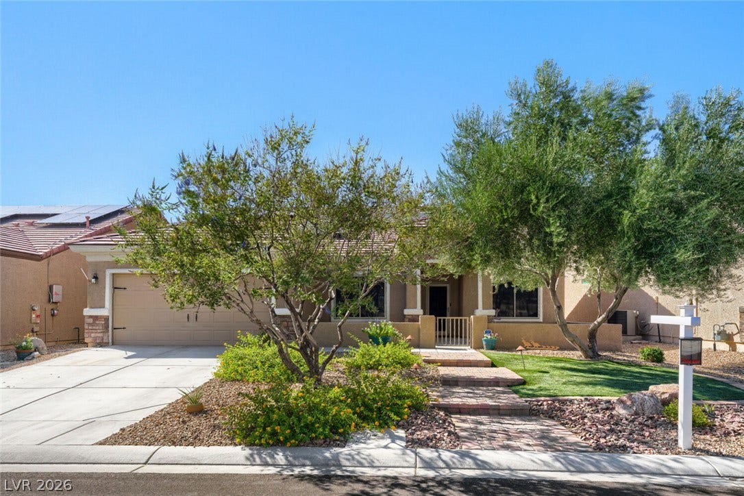 7421 Shelduck Street, North Las Vegas, NV 89084 Lush landscaping and a paved walkway lead to this inviting stucco home with tile roofing.