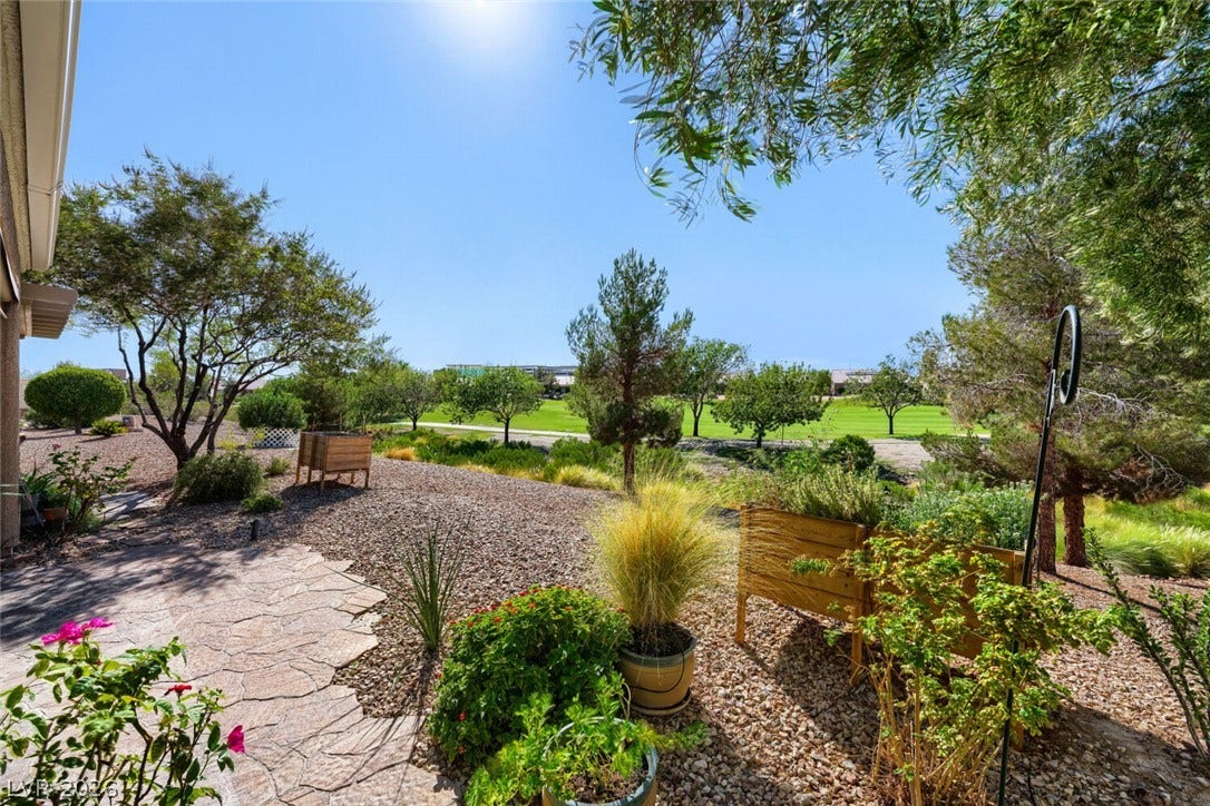 7421 Shelduck Street, North Las Vegas, NV 89084 Mature trees frame beautiful golf course views from this spacious backyard retreat.