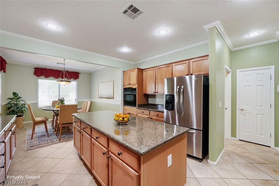 7421 Shelduck Street, North Las Vegas, NV 89084 An open floorplan seamlessly connects the functional culinary space to a bright dining area.