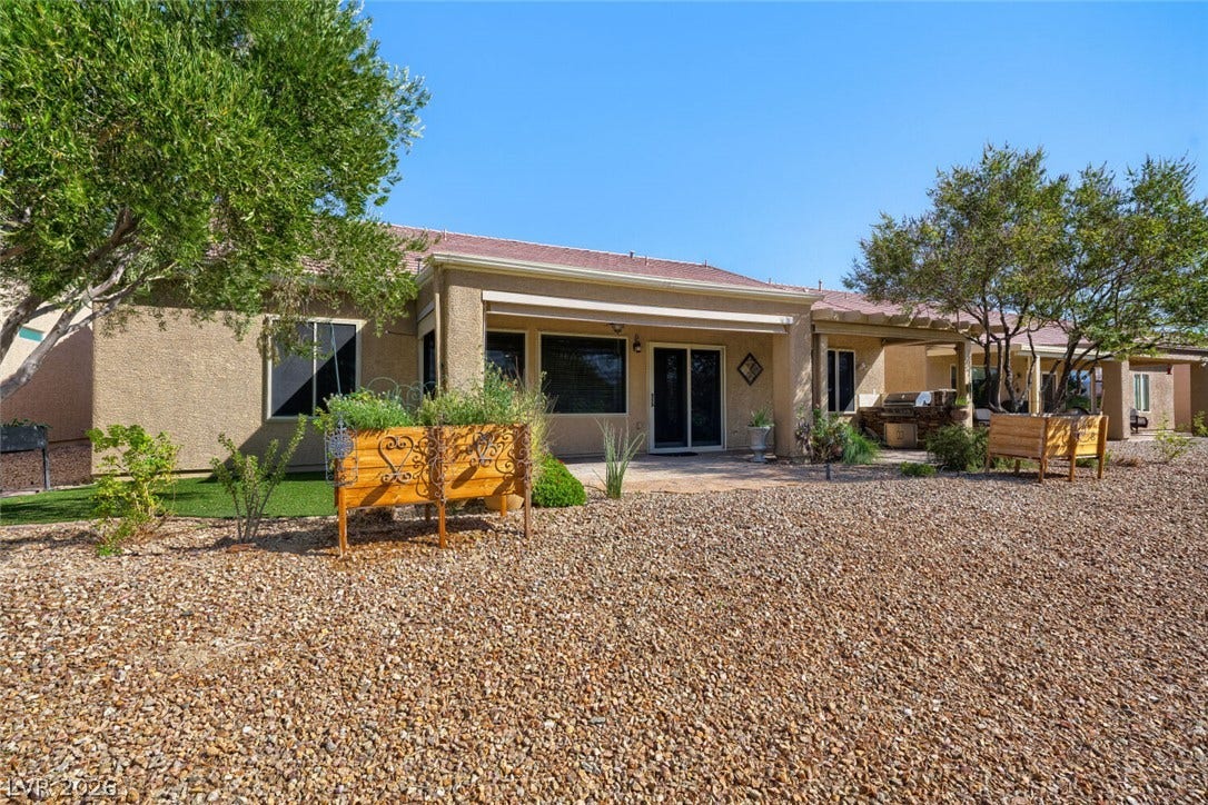 7421 Shelduck Street, North Las Vegas, NV 89084 A spacious covered patio overlooks the low-maintenance desert landscaping under clear blue skies.