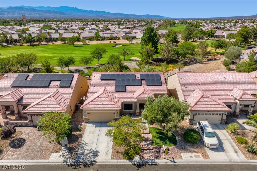 7421 Shelduck Street, North Las Vegas, NV 89084 Solar panels line the roof of this property overlooking a lush golf course green.