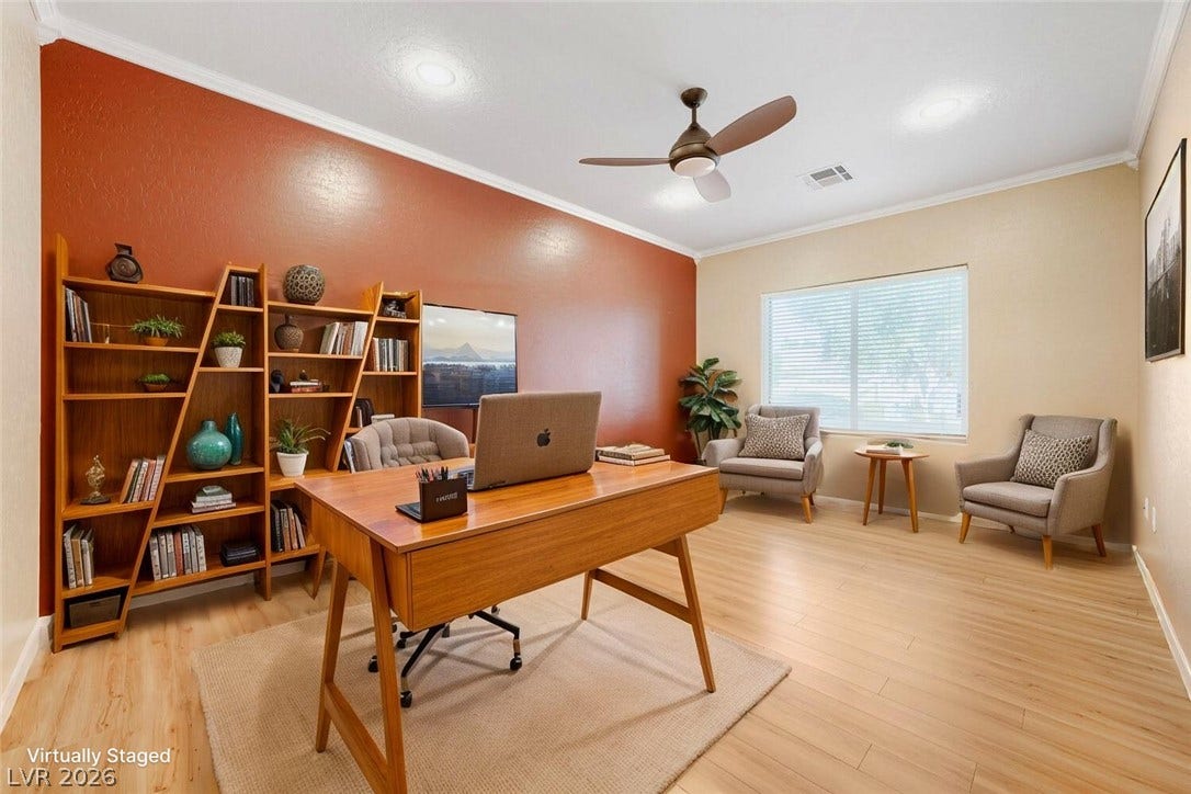 7421 Shelduck Street, North Las Vegas, NV 89084 Smooth wood-look flooring and crown molding frame this versatile workspace illuminated by natural light.