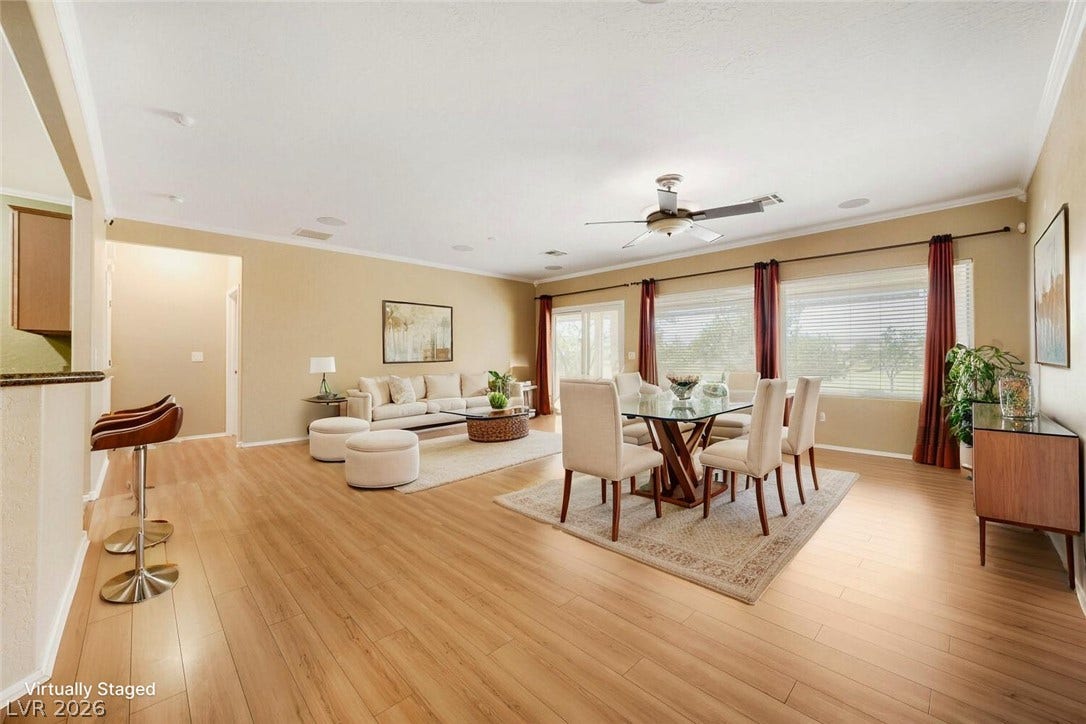 7421 Shelduck Street, North Las Vegas, NV 89084 Warm wood flooring and detailed crown molding enrich this airy open-concept living space.