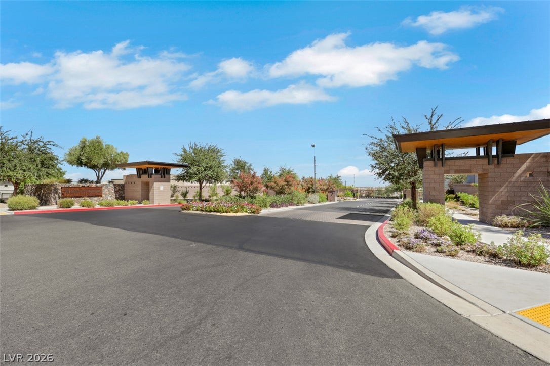 A secure gated entrance leads into the meticulously landscaped Ironwood community.