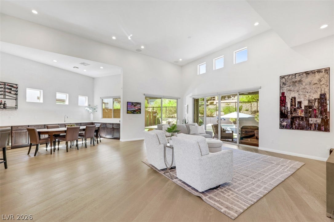 Stylish and inviting, this expansive great room flows through seamless glass doors to a beautifully  maintained backyard, sparkling pool & spa, and stunning mountain views.