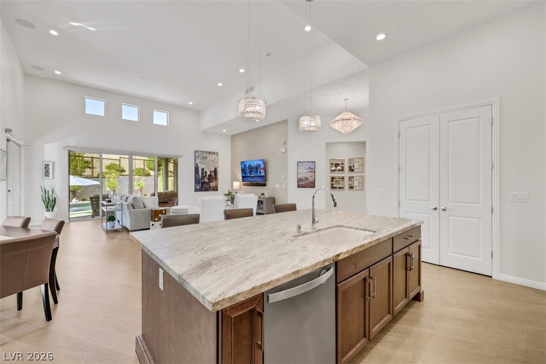 Gorgeous oversized granite island complements the warm cabinetry, creating an inviting place for cooking, gathering and entertaining.