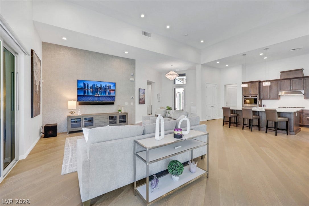 Soaring ceilings and light wood floors define this contemporary open layout for entertaining, relaxed mornings, and memorable gatherings.