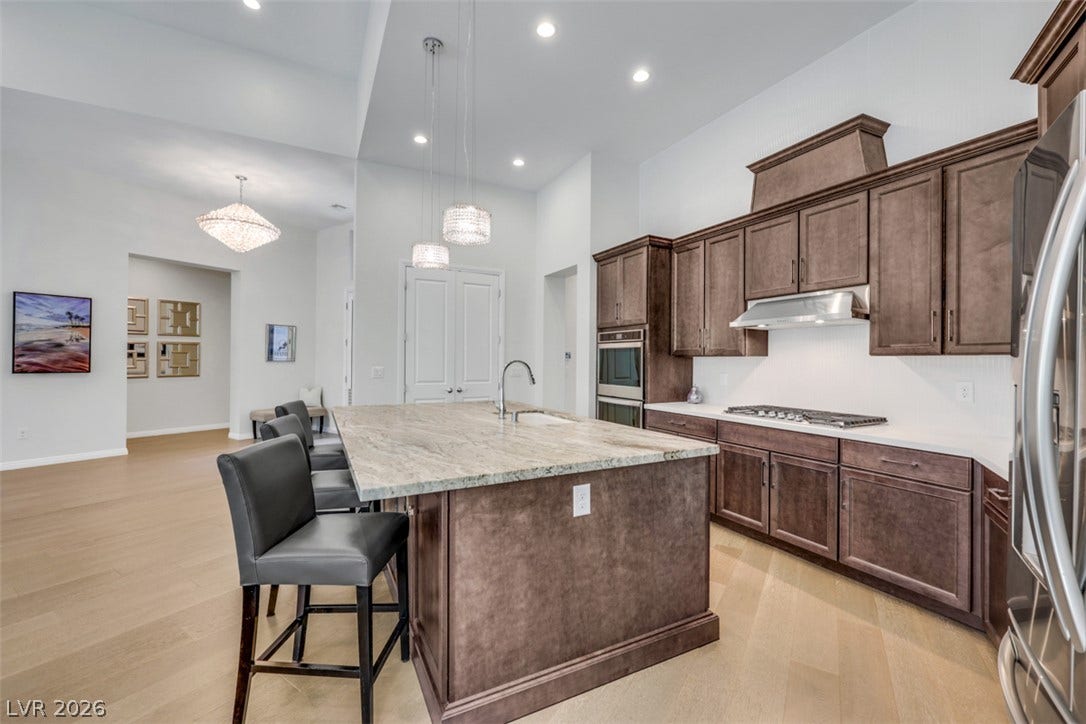 Rich, warm cabinetry, creates the perfect space for gatherings  and everyday luxury.