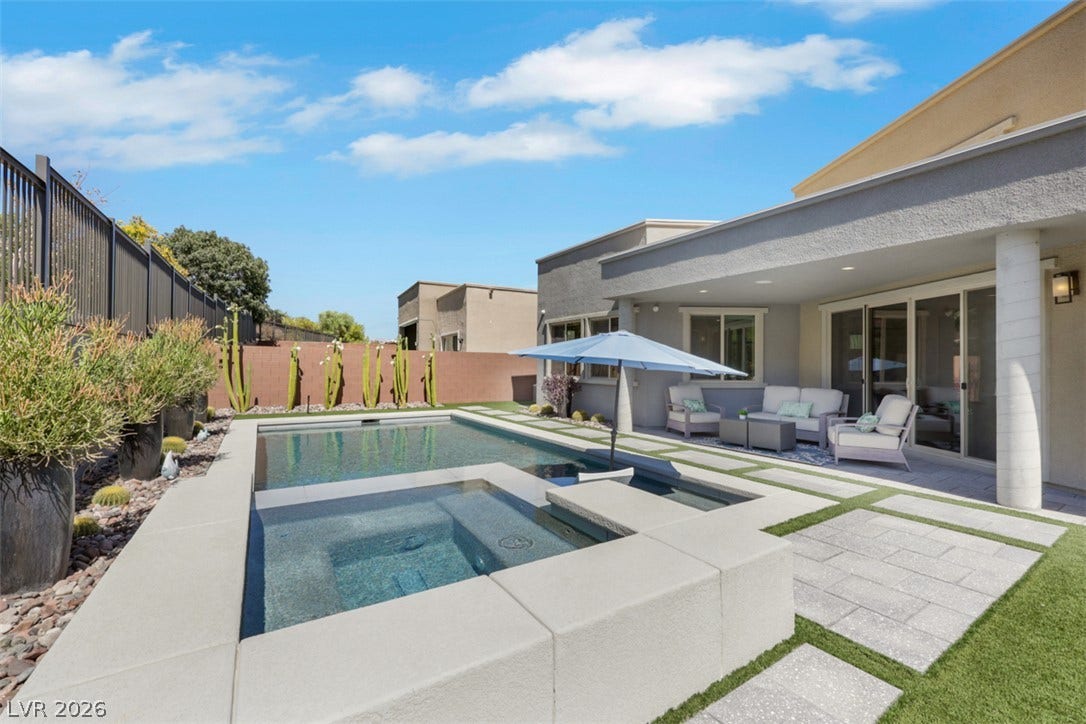 Resort-inspired pool & private spa is beautifully framed by lush turf & elegant stone pavers creating a outdoor oasis.