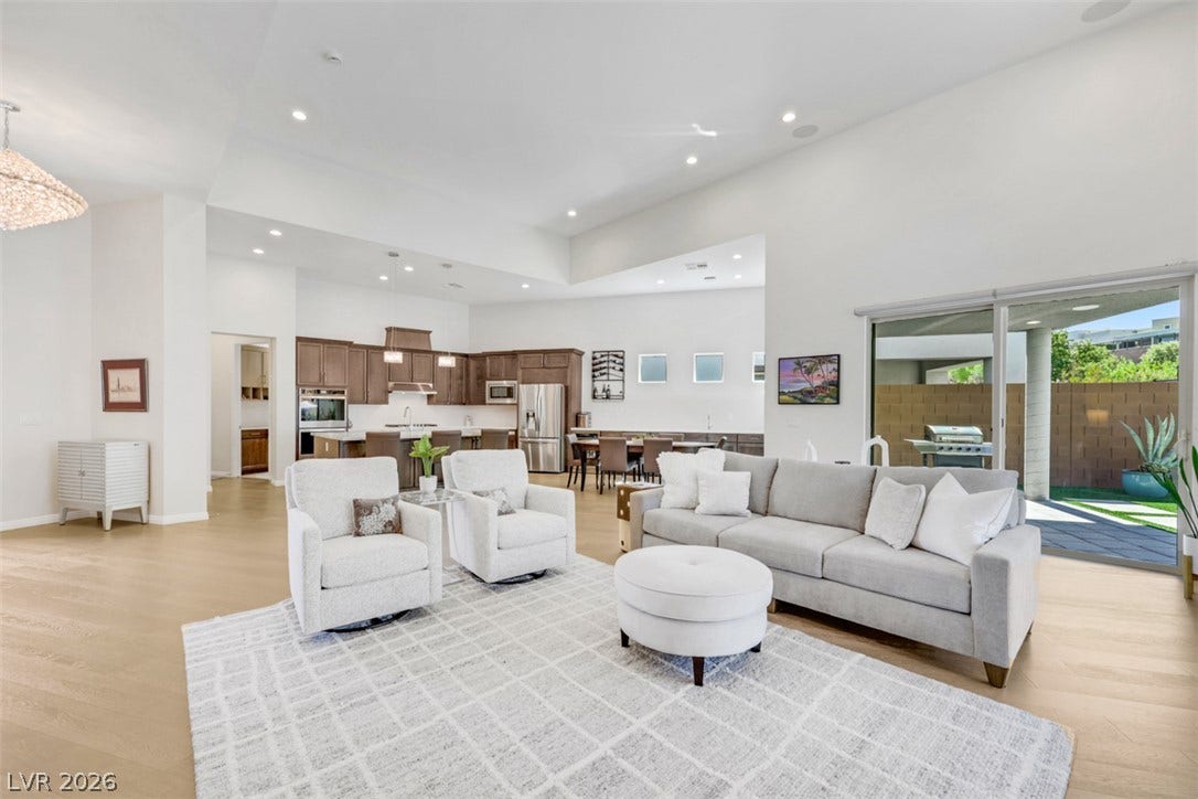 Soaring ceilings, warm wood flooring, a sleek modern kitchen, and an open floor plan set the stage for seamless upscale living.