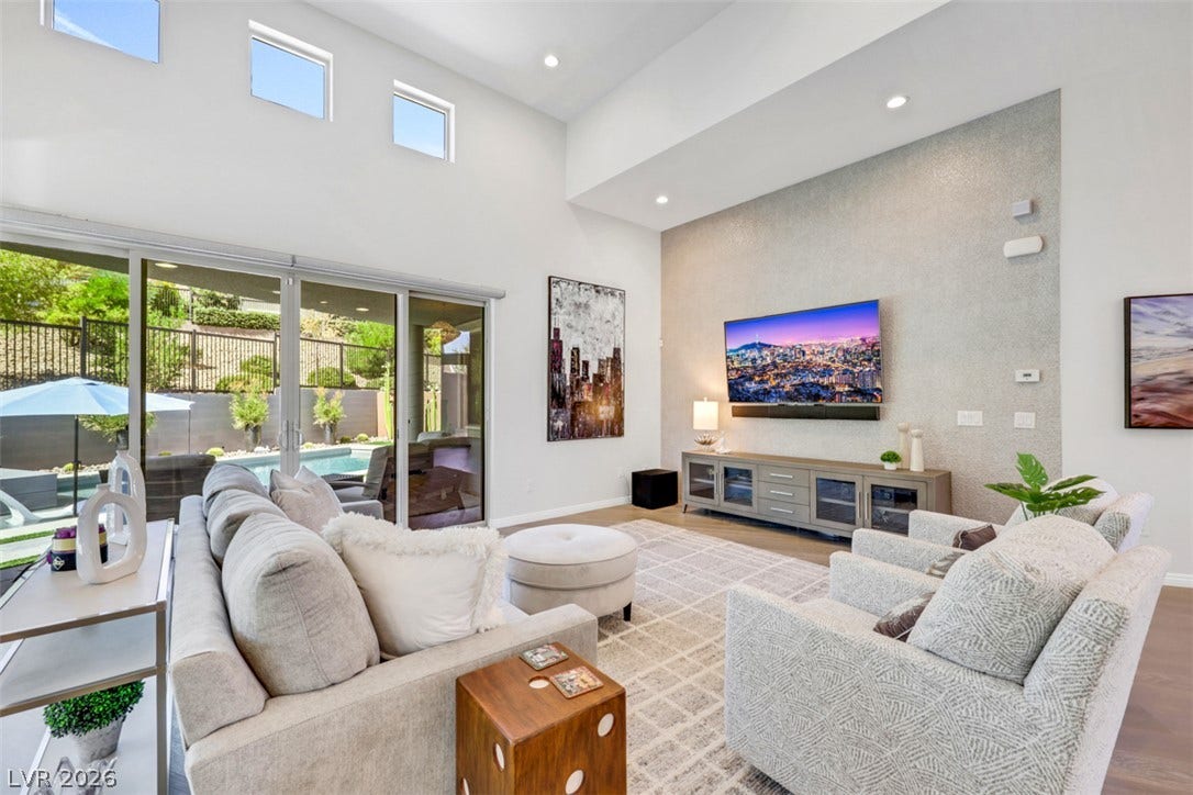 Wall-to-wall glass sliders create an airy, modern living space.