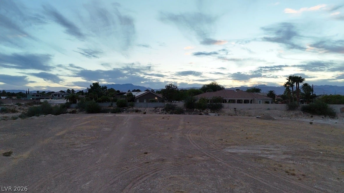 Lindell, Las Vegas, NV 89118 Distant mountain ridges frame this open acreage, highlighting a scenic horizon at twilight.