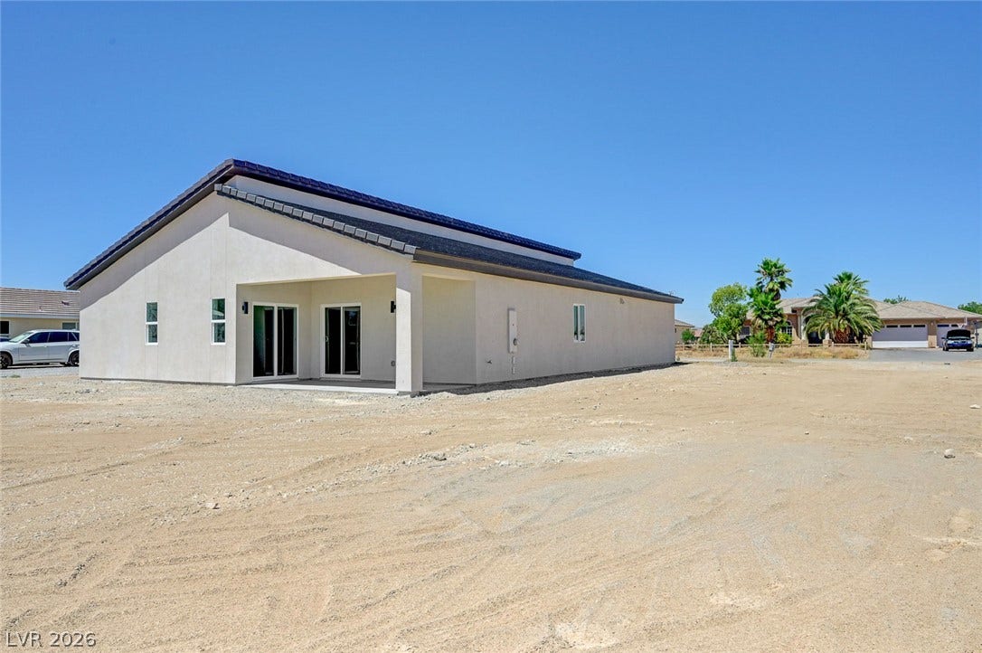 Clean lines and a covered rear porch highlight the architectural profile of this stucco home.
