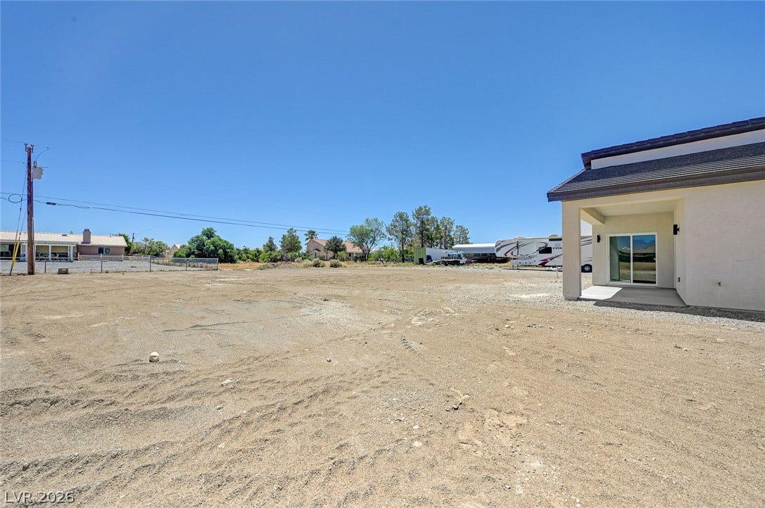 An expansive rear yard provides unlimited potential alongside a covered back patio.