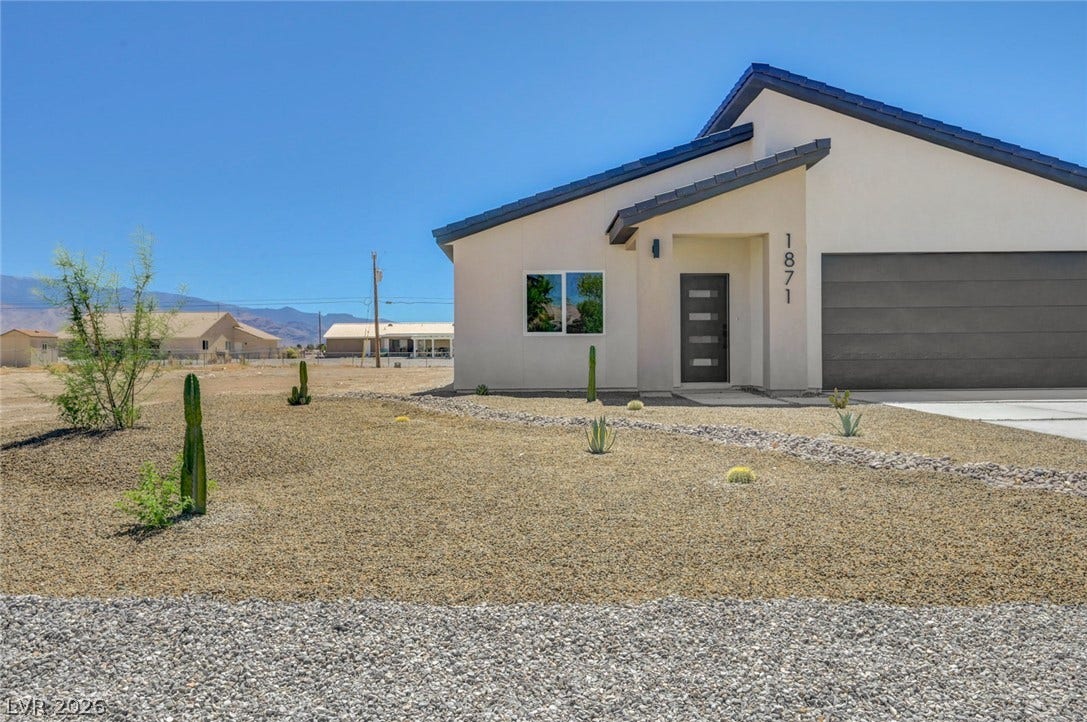A modern desert exterior is defined by clean stucco lines and minimalist native landscaping.